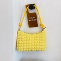 Vibrant yellow popcorn textured shoulder bag with stylish rope handle and metallic knots - Yellow