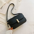 Classic black leather-textured crossbody square bag with gold buckle on white fabric - Black