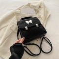 Chic black vintage butterfly backpack featuring white bow detail and silver buckles - Black