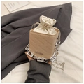 Detail of beige bucket bag with rich rabbit embossing and chunky silver chain strap - Khaki