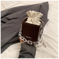 Detail of dark brown leather crossbody bag with letter embossing and silver chain handle - Brown