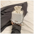 Detail of white bucket bag featuring rich rabbit embossed letters and silver chain strap - White