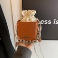 Brown leather drawstring bucket bag with rich rabbit embossing and silver chain strap - Brown
