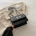 Schwarze gesteppte Tasche mit silberner Schleife und mit Leder durchzogener Kette - Schwarz