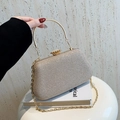 Elegant champagne gold sequin handbag with gold metal handle and chain shoulder strap - Gold