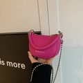 Mini magenta crossbody bag with silver star studs and chain strap in hand - Purple