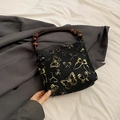 Chic black fabric tote with gold butterfly embroidery and wooden bead handle - Black