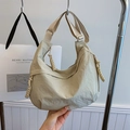 Chic beige nylon crescent bag featuring an adjustable strap and braided zipper detail - Off-white