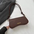 Dark brown crocodile-textured baguette shoulder bag with gold logo and leather cord straps - Brown