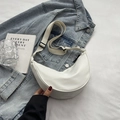 Minimalist white nylon crescent crossbody bag with adjustable strap on denim jacket - White