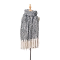 Detailed view of thick knit winter scarf with grey-white marl weave and long white tassels - Black