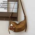 Dark brown faux leather crescent bag with fashion label and plush charm on wood stand - With Monster Pendant / Brown