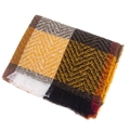 Macro shot of thick herringbone weave texture and soft tassel fringe on plaid scarf - Yellow
