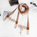 Detail of soft brown and white patchwork scarf with fringes styled with elegant accessories - Camel