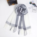 Flat lay of grey and white checkered cashmere-like scarf with fringe and fashion accessories - Gray