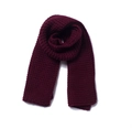 Close-up of thick knitted wine red scarf showing detailed chunky knit wool texture - Burgundy
