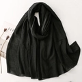 Detailed close-up of a black cotton linen scarf with elegant silver thread edging - 190x86cm / Black