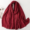 Close-up of deep red cotton linen scarf showing natural wrinkled texture and stitched edges - 190x86cm / Wine Red