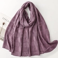 Close-up of deep purple pleated scarf with textured fabric next to a lifestyle magazine - Purple (SL2511-007)