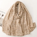 Elegant beige shawl with gold heart patterns and artistic Cereal magazine background - Khaki