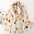 Off-white lightweight scarf with gold foil polka dots and soft fringed edges on white background - Beige