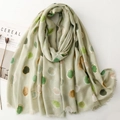 Light green long scarf with gold foil dots and fringe, displayed with a lifestyle aesthetic - Green
