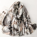 Elegant floral satin scarf with gold stamping and fringed edges on minimalist background - Black and Gray