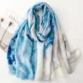 Écharpe tie-dye bleu et blanc avec détails dorés et franges sur fond blanc épuré - Bleu