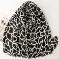 Long scarf with black and white geometric pattern and fringe edges on a white background - Black