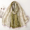 Detail of green and beige paisley patterned shawl with elegant ethnic floral textures - Green