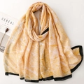 Detail of a chic ginger yellow hand-painted print scarf with stylish black borders - Yellow