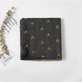 Detailed view of dark grey cotton scarf with golden reindeer print and tassel edges - Deep Heather Grey