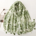 Detail of white cotton scarf with green paisley patterns and fringed tassels on edges - Green