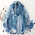Blue palm leaf printed scarf with tassels and breathable fabric laid flat on a white surface - Blue