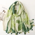 Detail of tropical green leaf print scarf with alternating two-tone decorative tassels - Green