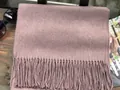 Gray-pink wool scarf with classic fringe tassels laid on a wooden surface - Gray Pink