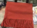 Solid rust red wool blend scarf with classic fringe tassels on a wooden park bench - Rust Red