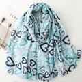 Light blue linen feel scarf featuring gold-foil heart patterns and frayed edge detailing - Blue