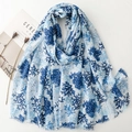 Detail of blue coral pattern scarf with gold foil dots and soft fringed edges - Blue