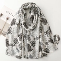 Linen feel coral print scarf with gold foil accents and frayed edges on white background - Black and Gray