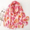 Linen feel coral print scarf in pink and orange with gold accents and frayed edges - Rose Pink