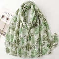 Detail view of light beige linen-feel scarf with green coral pattern and gold foil accents - Green
