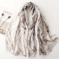 Elegant marble print scarf with gold foil accents and raw edges on a white background - Gray