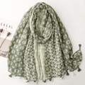 Detailed view of bohemian geometric star patterns and two-tone tassels on a green scarf - 180x88cm / Green