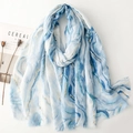Detail of blue and white marble pattern scarf with gold foil lines and fringe edges - Blue