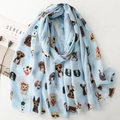 Light blue scarf featuring cartoon dog prints with sunglasses and natural frayed edges - Blue