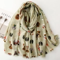 Macro detail of dog print scarf with fringed edges and soft pastel green fabric texture - Green