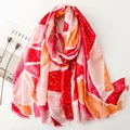 Detail of colorful scarf with gold foil accents and fringe edges on a white surface - Red (SL2502-016)