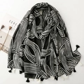 Minimalist black and white geometric scarf with tassels shown in a flat lay setup - Black With White Stripes (SL2502-015)