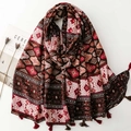 Detail of bohemian geometric shawl with cotton-linen feel and fringe tassels on white background - Red